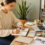 How to Learn a New Skill: A Practical Step-by-Step System for Beginners 2 Woman learning a new skill, writing in notebook at desk with laptop.